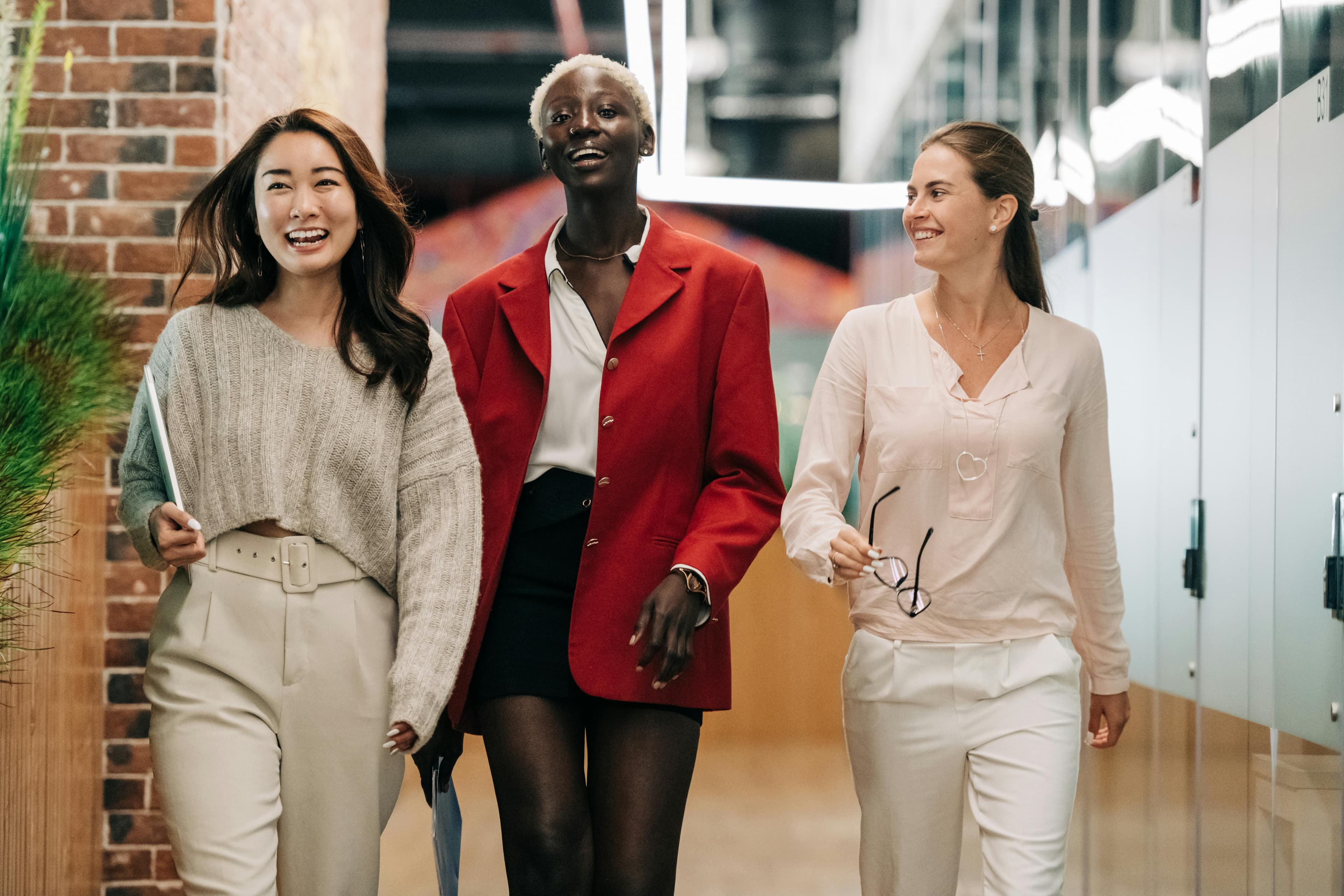 Three professional women walking confidently